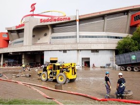 Clean-up crews work at the Saddledome on Monday. By Tuesday, all of the floodwater had been pumped out. Now the restoration process can begin, a mammoth task which could see workers going around the clock.