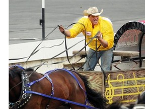 Colleen De Neve/ Calgary Herald CALGARY, AB --JULY 4, 2014 -- The Cowboys Casino Posse chuckwagon driver Jason Johnstone guided his team out of the starting area during heat 1 of the Rangeland Derby at the Calgary Stampede on July 4, 2014. Johnstone was drving his father Reg Johnstone's rig. (Colleen De Neve/Calgary Herald) (For Sports story by Lawrence Heinen) 00056705A SLUG: CHUCKWAGONS