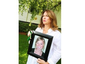 Colleen Ransom holds a photograph and the green velvet bag that had contained some of the ashes of her daughter Emma. (Calgary Herald/Files)