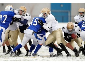 Colton Hunchak, No. 5, dives through a hole during Notre Dame’s 44-15 win over the Harry Ainlay Titans from Edmonton in ASAA Regional Finals last November.