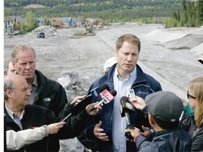 Construction forges on along Cougar Creek in Canmore as Rick Fraser, associate minister for both public safety and recovery and reconstruction of High River, discusses the area’s reconstruction with media Thursday.