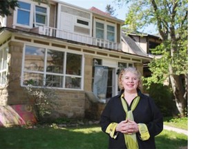 Cory Miller stands in front of her 1912 Elbow Park heritage home that she is restoring after it was flooded last year. Miller has been nominated for a Lion Award by the Calgary Heritage Authority for her efforts to preserve her historic home after last year’s floods.