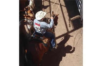 Cowboy Dean Edge from Rimbey Alberta practices his throw before the Tie-Down Roping event at the Calgary Stampede.