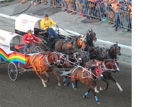 Rae Croteau Jr. i his rainbow wagon tries to overcome Gary Gorst to place second in race seven, of the GMC Rangeland Derby Chuckwagon Races on day nine at the Calgary Stampede Saturday.