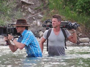 Cutline: Hell or High Water: Rebuilding the Calgary Stampede director Matt Embry (r) looks on as Director of Photography Patrick McLaughlin (l) frames a shot.