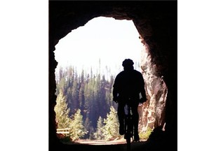 Cyclists and hikers travelling the Myra canyon portion of the Kettle Valley Railroad pass through two refurbished tunnels.