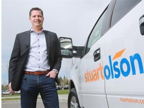 David LeMay, CEO of Stuart Olson Inc., stands next to a truck with the company’s new logo in Calgary on Friday.