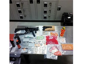 Red Deer police display drugs, cash and replica weapons seized during a search of a Kentwood neighbourhood home.