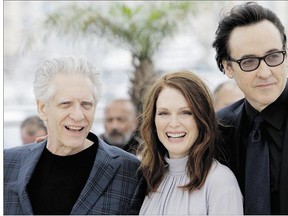 Director David Cronenberg, left, with Maps to the Stars stars Julianne Moore and John Cusack at Cannes. The Canadian director says his newest film goes beyond show business.