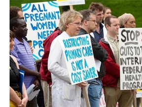 Doctors and other healthcare providers protest the federal governmentís cuts to refugee health care benefits at the Grand Parade in Halifax on Monday, June 17, 2013. THE CANADIAN PRESS/Andrew Vaughan