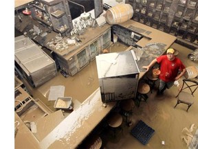 Dominic Caracciolo, of the Wurst Restaurant and Beer Hall, in the flooded lower floor of the establishment in June 2013.