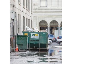 A Dumpster blocking the laneway between 7th and 8th Avenue at Centre Street in Calgary is causing delays to securing a permit to build a first-of-its-kind mechanized parkade in downtown Calgary.