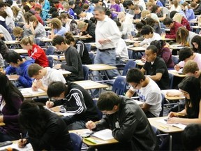 High school students write exams in this file photo.