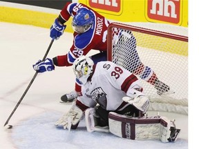 Edmonton Oil Kings Mitchell Moroz of Calgary tries a wrap-around shot on Guelph Storm goalie Justin Nichols during their round-robin meeting at the Memorial Cup. Edmonton later beat Guelph in the final.