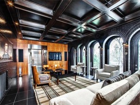 Elegant arched windows and a luxurious coffered ceiling are highlights in the family room.