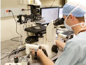 An embryologist at work in the Regional Fertility Program lab in Calgary. The clinic, which has operated since the 1980s, won’t allow a woman to use a sperm donor “that would result in a future child appearing racially different than the recipient or the recipient’s partner.”