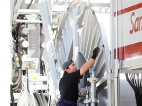 An employee cleans a Sanjel coiled tubing unit before the Global Petroleum Show in Calgary in 2012.