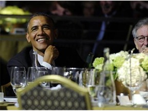 President Barack Obama, left, sits next to movie director Steven Spielberg, right, as they listen to Conan O'Brien during the USC Shoah Foundation’s 20th anniversary Ambassadors for Humanity gala in Los Angeles, Thursday, May 8, 2014. Obama received an award from the foundation created by Spielberg and is spending three days in California where he plans to raise money for the Democratic Party. (AP Photo/Susan Walsh)