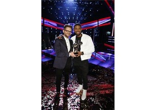 Josh Kaufman, left, poses with his trophy with Usher after the 38-year-old from team Usher was crowned the season six winner of NBC’s “The Voice” Tuesday May 20, 2014. (AP Photo/NBC, Trae Patton)