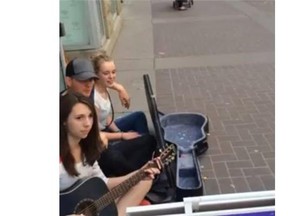 Michael Buble sings with some buskers on Stephen Avenue in Calgary on Monday.