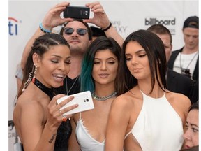 Jordin Sparks (L) takes a selfie with models Kendall Jenner (R) and Kylie Jenner (C) as they arrive for the 2014 Billboard Music Awards, May 18, 2014 at the MGM Grand Garden Arena, in Las Vegas.