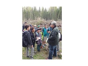 Environment Minister Robin Campbell talks to a group of students with Inside Education, which uses the outdoors as a teaching tool. The province announced $10 million to repair trails and bridges on public lands outside of the provincial parks.
