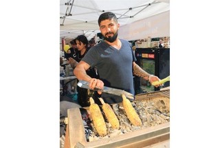 Essa Ashour with the Arch Persian Lounge cooks corn over hot coals at the Tabestoon Festival in Olympic Plaza on Saturday afternoon July 26, 2014. 
 Gavin Young/Calgary Herald