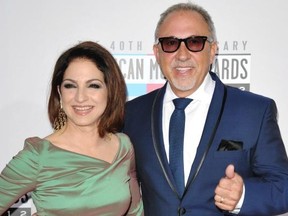 FILE - The Nov. 18, 2012 file photo shows singer Gloria Estefan, left, and Emilio Estefan, Jr. at the 40th Anniversary American Music Awards in Los Angeles. Gloria Estefan and her husband Emilio Estefan are hoping to develop a stage musical about their lives. Producers said Tuesday, May 20, 2014, ìOn Your Feet!î will premiere in Chicago this summer before landing at a Nederlander theater in the fall. Jerry Mitchell, who directed ìKinky Boots,î will helm the show, with Sergio Trujillo choreographing. The story will be written by Alexander Dinelaris. (Photo by John Shearer/Invision/AP, file)