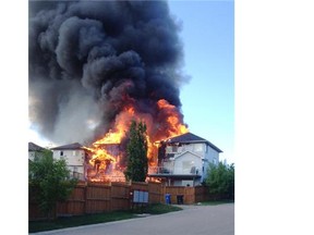 Flames engulf three homes on Evansmeade Circle on Friday evening.