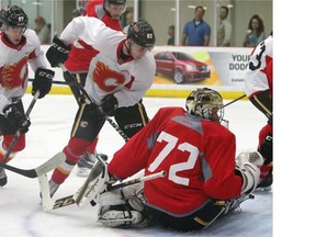 Flames rookie Sam Bennett tries to jam the puck past goalie Mason McDonald during the NHL team’s scrimmage at WinSport’s ice complex on Monday.