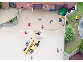 Flood waters surround the hospital in Canmore on Friday. The hospital remains open, but officials with Alberta Health were monitoring the situations and preparing to evacuate patients if necessary.