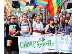 Former premier Alison Redford, centre, made history by becoming the first premier to march in a Pride parade last year.