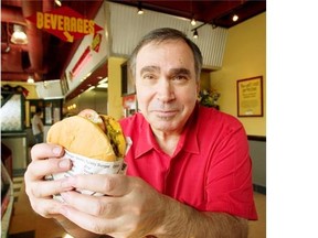 Frank Di Benedetto shows off a Fatburger at the chain’s first Calgary outlet at Deerfoot Meadows a few years ago.