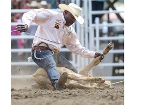 Fred Whitfield, from Hockley, TX, competes in and wins the tie-down roping at the second day of rodeo at the 2014 Stampede in Calgary, on July 5, 2014.