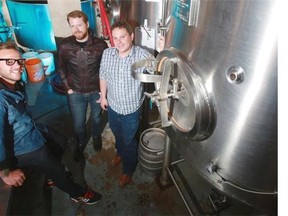 From left, Last Best Brewing and Distilling co-owner Socrates Korogonas, brewery operations manager Phil Brian and co-owner Brett Ireland stand next to brewing tanks in what will be their brewpub in the Beltline. Last Best beers are already available at numerous spots in the city. Photo by Gavin Young, Calgary Herald.
