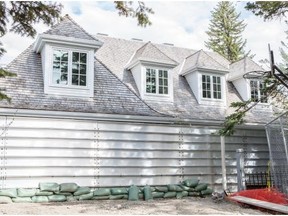 The front of Allan Markin’s home along the Elbow river where a giant wall has been erected. (Jenn Pierce/Calgary Herald)