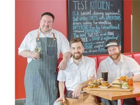 Garth Brown, the conceptualist behind the test kitchen concept, left, Kenton Hrynyk, beverage director, centre, and Chad Taylor, chef, right, serve up a board of their lunch time favourites at the Test Kitchen in Calgary.