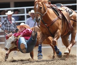 Gavin Young, Calgary Herald 
 CALGARY, AB: JULY 04, 2014 -- Straws Milan from Cochrane AB competes in the steer wrestling at the Calgary Stampede rodeo on Friday July 4, 2014. 
 Gavin Young/Calgary Herald 
 (For Sports section story by TBA) Trax# 00056704A