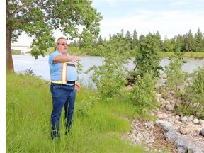 Doug Marter, the City's Parks planning and development manager, points out areas of damage along the Bow River in Bowness Park being refurbished after last year’s flooding. Bowness Park was undergoing a three-year re-development when it was damaged in the 2013 flood.