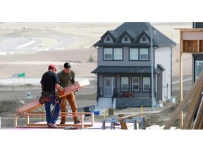 Gavin Young/Calgary Herald 
 Workers build homes in Nolan Hill in northwest Calgary. Shovels turned in 630 homes in the Calgary CMA last month, up from 545 during the same time in 2013.