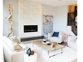 The great room in the Hawthorne by Homes by Avi in King’s Heights features a stone fireplace.
