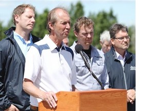 High River Mayor Emile Blokland speaks to the media with Rick Fraser, left, associate minister of regional recovery and reconstruction, Doug Griffiths Minister of Municipal Affairs and Colin Lloyd, managing director municipal affairs announced how people who have been evacuated will be getting those cash debit cards on Wednesday as unrest continues to grow with people who want to get back into their homes in High River on June 36, 2013.