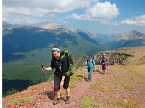 Hikers enjoy the views on Akamina Ridge with Waterton Lakes National Park in the background.