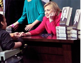 Hillary Clinton meets a woman before signing a copy of her new book at a Barnes and Noble bookstore in New York.