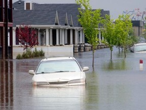 Homes and cars remain underwater two weeks after the flood in High River. (Calgary Herald/Files)