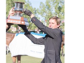 Ireland’s Darragh Kenny takes home the Encana Cup riding Picolo at Spruce Meadows on Friday night.