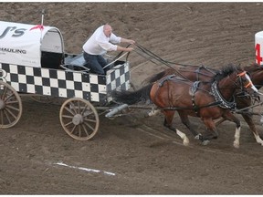 Jason Glass drives his team down the final straightaway during heat 9 of day 8 of the GMC Rangeland Derby chuckwagon races at the Calgary Stampede. Glass won the aggregate title with the race win.