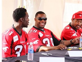 WR Jeff Fuller, left. DL  Charleston Hughes and LB Deron Mayo, wait to sign autographs as the Calgary Stampeders hosted their annual Fanfest  event on May 24, 2014.