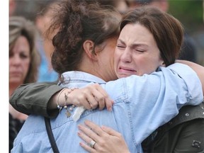 Jennifer O’Brien, mother of missing five-year-old Nathan O’Brien, is consoled upon arriving at Thursday’s candlelight vigil.