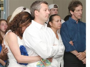 Jennifer O’Brien with her husband Rod at a press conference regarding their missing family members at Calgary Police headquarters.